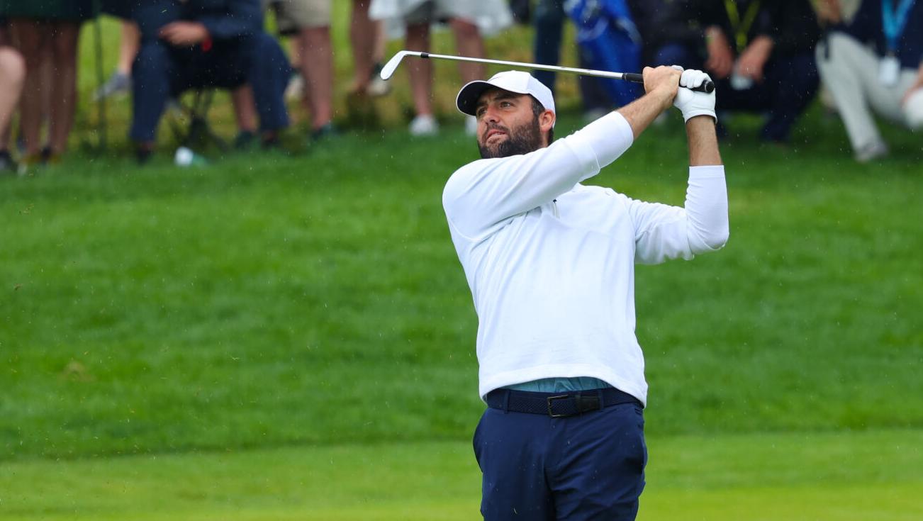 Scottie Scheffler hits an iron on fairway.JPG